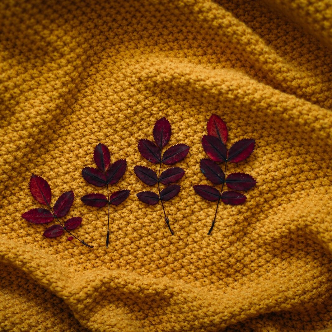 Four Brown Leaves On Textile